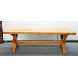 A modern oak kitchen table of 17th century design with a plank top on pegged frame base, 101cm...