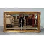 A 20th century gilt framed rectangular mirror, with shell moulded frame