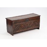 A 17th century oak five plank coffer, with carved front panel, on slab end supports, 120cm...