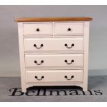 A modern white painted chest with oak top over two short and three long drawers