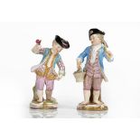 Two Meissen figures of boy gardeners, late 19th, one modelled carrying a rake and basket of...
