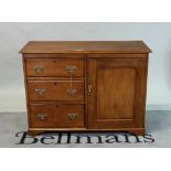 An early 20th century fruitwood side cabinet with three short drawers