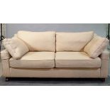 A modern hardwood framed two seater sofa