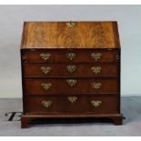 A George III mahogany bureau with four long graduated drawers