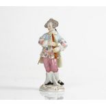 A Meissen figure of a musician, 20th century, modelled as a young man standing with a pipe,...