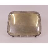 A George III rectangular salver, decorated with a gadrooned rim, raised on four tapered feet...