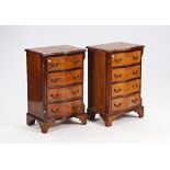 A pair of George III style mahogany serpentine three drawer bedside tables (2).