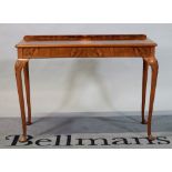 A George III style walnut side table on shell capped cabriole supports