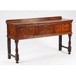 A mid-18th century oak three drawer dresser base, on baluster turned supports, 157cm wide x...