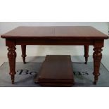 A late Victorian oak extending dining table on tapering turned supports with three extra leaves