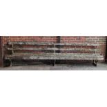A early 20th century garden bench on three cast iron supports