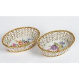 A pair of small Meissen pierced oval baskets, early 20th century, each painted to the...