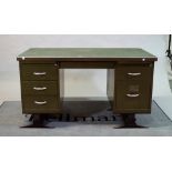 A mid-20th century green painted metal kneehole desk with six short drawers