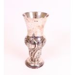 A silver vase, the body embossed with spiral fluting and foliate sprays, raised on a circular...