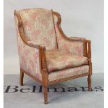 A late 19th century satinwood framed wingback easy armchair, on turned supports