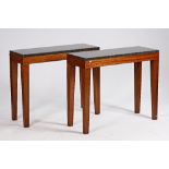 A pair of modern consoles, each with rectangular polished marble tops on four tapering...