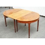A George III mahogany 'D' end dining table, the cross banded top on channelled tapering...