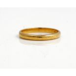 An 18ct gold plain wedding ring, ring size O, the hallmark rubbed, weight 2.9 gms.