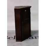 A 19th century oak hanging corner cupboard with panelled door