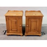 A pair of modern pine bedside cupboards