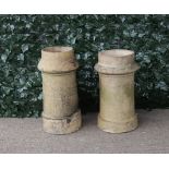 A similar pair of early 20th century terracotta chimney pots, 32cm diameter; 60cm high (2)