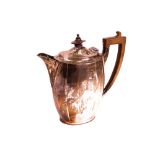 A silver hot water jug, of panelled oval form, with wooden fittings, Sheffield 1928, gross...
