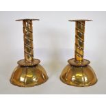 A pair of late 19th century brass candlesticks with cup bases and spiral stems