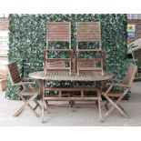 A modern hardwood oval folding garden table, 149cm wide; 75cm high