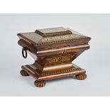 A Regency brass inlaid rosewood sewing box of exaggerated sarcophagus form with fitted...