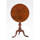 An 18th century oak circular snap top tripod occasional table, 57cm diameter x 69cm high.