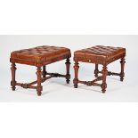 A pair of 19th century French brown button leather upholstered rectangular footstools on...