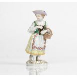 A Meissen figure of a girl, 20th century, modelled standing wearing a bonnet and dress,...