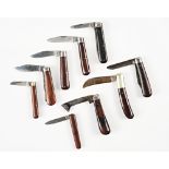 Eight wooden handled pocket knives (9)