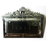 A 20th century etched glass cushion framed rectangular Venetian mirror with floral crest,...