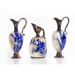 A pair of Doulton Burslem earthenware ewers, circa 1900, decorated with blue irises against a...
