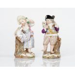 A pair of Meissen figures of a shepherd boy and girl, late 19th century, the boy carrying a...