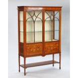 An Edwardian marquetry inlaid mahogany two door display cabinet.