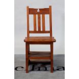 A modern hardwood metamorphic folding chair