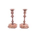 A pair of late Victorian small candlesticks, modelled as mid-18th century taper sticks,...