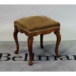 A Louis XV style walnut footstool on carved cabriole supports