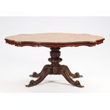 A shaped floral marquetry inlaid figured walnut centre table on turned column and four scroll...