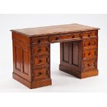 An oak pedestal desk with nine drawers about the knee, 123cm wide x 63cm deep.