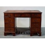 A modern mahogany pedestal desk, with inset leather top over nine drawers