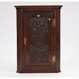 An 18th century oak and later carved corner cupboard with fitted interior, 78cm wide x 108cm...