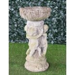 A reconstituted stone bird bath, with circular reservoir on cherub base, 47cm diameter x 92cm...