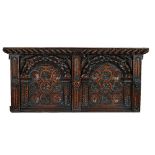 A 17th century style carved oak panel with gadrooned frieze and concentric circular decoration...