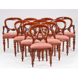 A set of ten Victorian style mahogany balloon back dining chairs, on baluster reeded supports,...