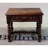 An 18th century style oak low side table with single carved drawer on spiral twisted supports