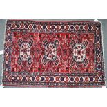 A Shirvan rug, Caucasian, the madder field with three ivory medallions supported by minor...