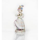 A Meissen figure of a girl holding a toy animal, late 19th century, modelled standing in a...